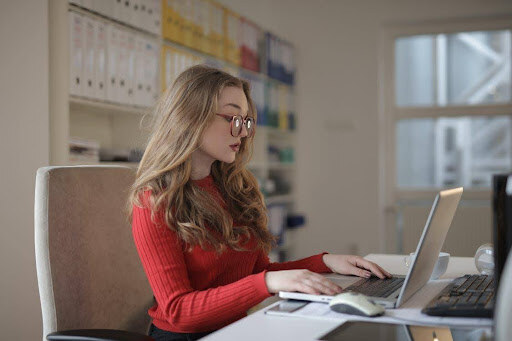 focused woman working on accounting internal control with laptop